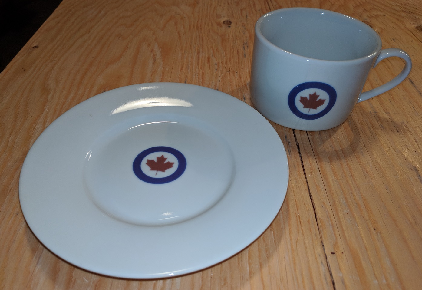 Custom printed porcelain cup and saucer with Canadian maple leaf emblem, printed, glazed, and kiln-fired in Ontario by Paris Group Inc.